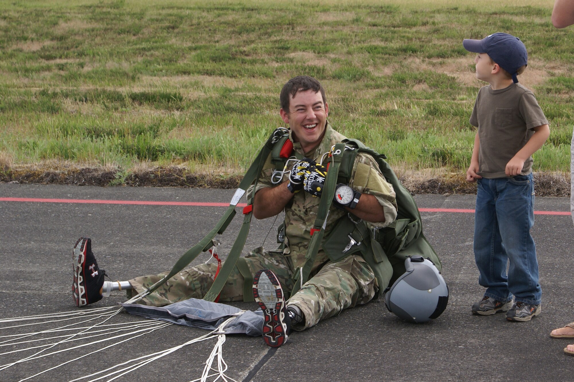 Staff Sgt. Shaun Meadows, 22nd Special Tactics Squadron, shares a laugh with his son after completing a personnel drop June 14. (U.S. Air Force photo/Airman Leah Young)