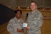 MINOT AIR FORCE BASE, N.D. – Staff Sgt. Kenyata Jenkins, 5th Force Support Squadron fitness center program manager, congratulates Staff Sgt. Scott Mabrey, 5th Aircraft Maintenance Squadron unit facility safety manager, for being the overall winner in the male category of the 2010 “Biggest Loser” program.  Sergeant Mabrey lost 29 pounds during the competition and received a $200 gift certificate from Val’s Cyclery in Minot for his efforts.  The “Biggest Loser” program ended May 28. (Courtesy photo by Debra Vangsness)