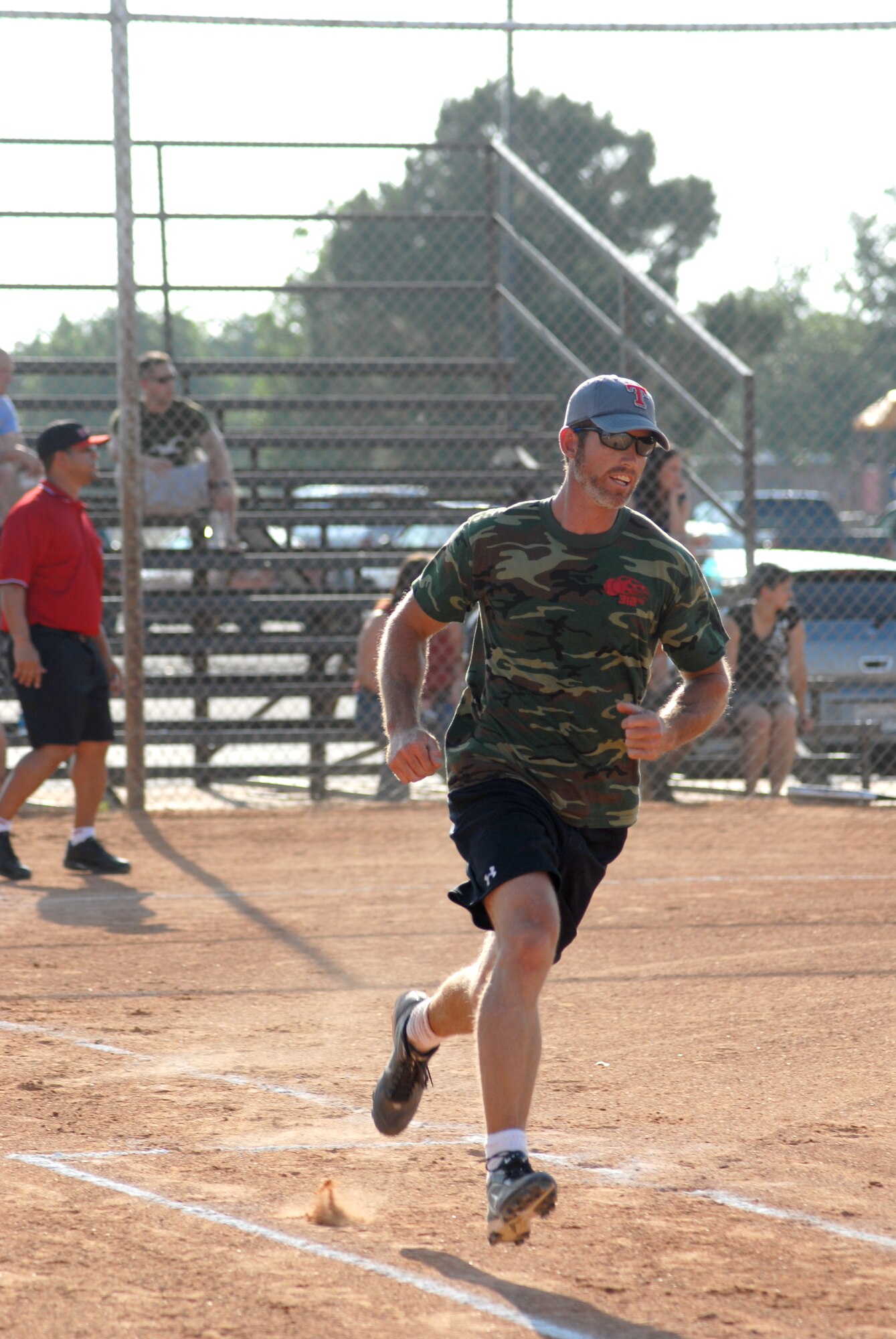 Eric Aker, 312th Training Squadron Fire Dawgs, heads to first base for a base hit during a game against the Navy/Marines softball team.  The Fire Dawgs went on to defeat the Navy and Marines 26 to 7. (U.S. Air Force photo/Master Sgt Randy Mallard)