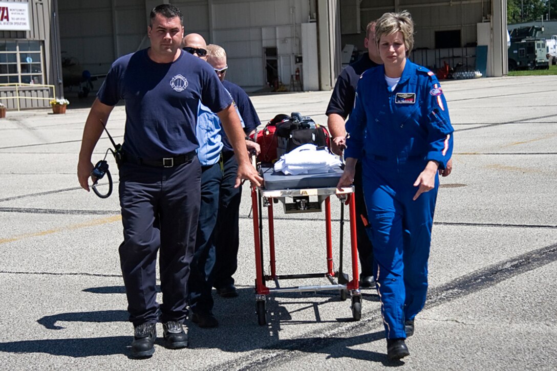 GRISSOM AIR RESERVE BASE, Ind. -- Grissom Fire Department Capt. Mark Fackler along with other Grissom Firefighters and Lisa Stringer, a flight nurse with a local medical helicopter transport team, simulate transporting a patient to a medevac helicopter during a training exercise. (U.S. Air Force photo/Tech. Sgt. Mark R. W. Orders-Woempner) 
