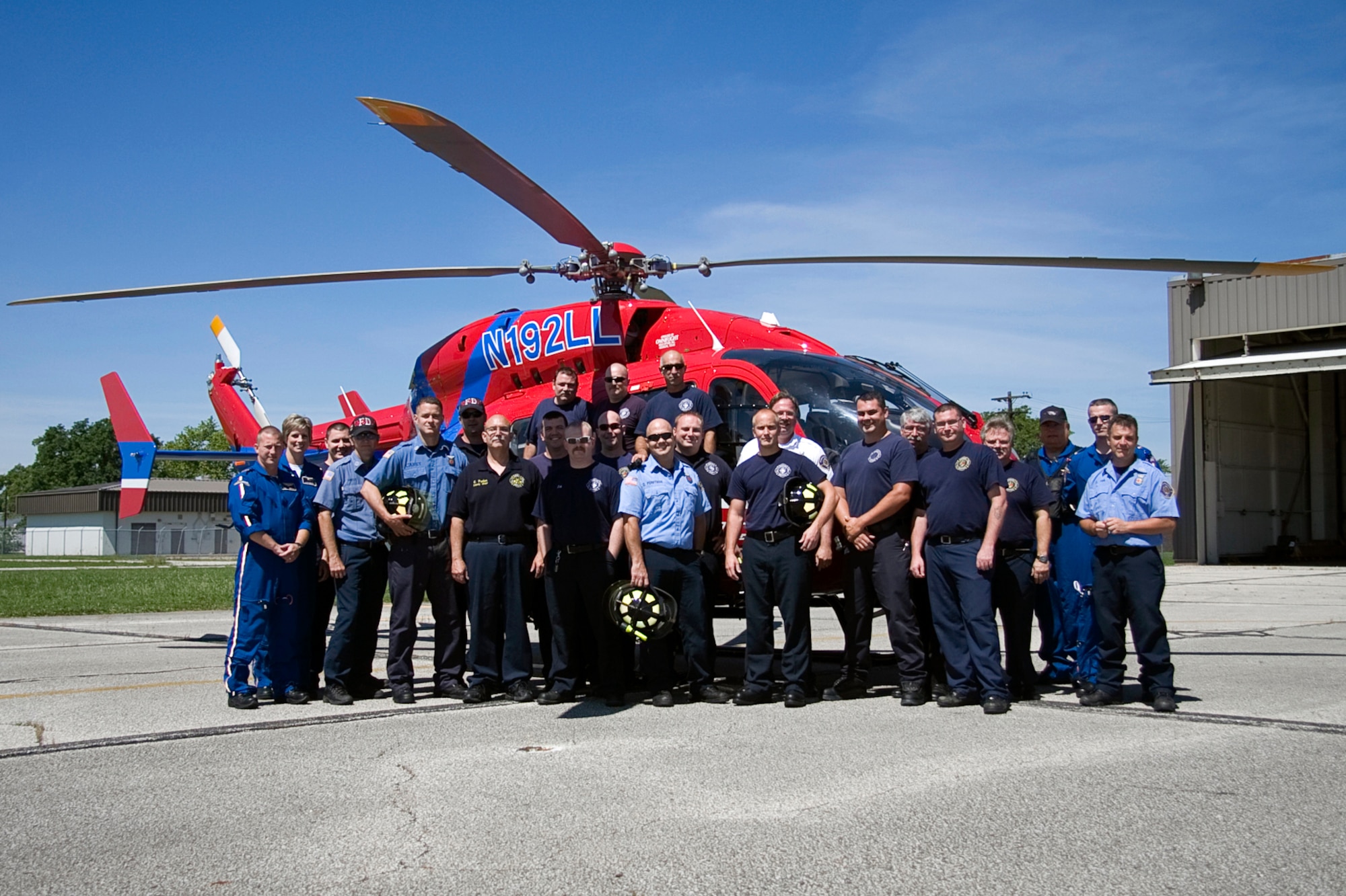 GRISSOM AIR RESERVE BASE, Ind. -- Members of the Grissom Fire Department and a medical transport helicopter crew pose for a photo during training. The training provided the firefighters with hands-on experience in safely loading patients into a medical transport helicopter even while it was still running. The helicopter crew was based out of Kokomo, Ind., and consisted of a pilot and three flight nurses. (U.S. Air Force photo/Tech. Sgt. Mark R. W. Orders-Woempner)