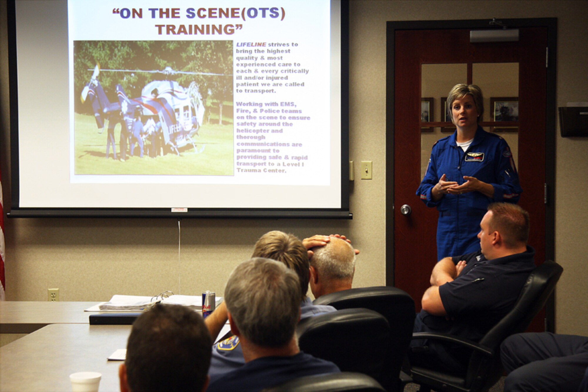 GRISSOM AIR RESERVE BASE, Ind. -- Lisa Stringer, a flight nurse with a local medical helicopter transport team, briefs Grissom firefighters about on-the-scene training they were about to undertake June 10. The firefighters got a hands-on training experience that gave them experience in transporting and loading patients into a running medical transport helicopter. The firefighters practiced both "hot" and "cold" loads. A hot load is a term used to describe when a patient is loaded into a helicopter while it is still running. A cold load is a term used to describe loading a patient when the helicopter is shut down. (U.S. Air Force photo/Tech. Sgt. Mark R. W. Orders-Woempner) 
