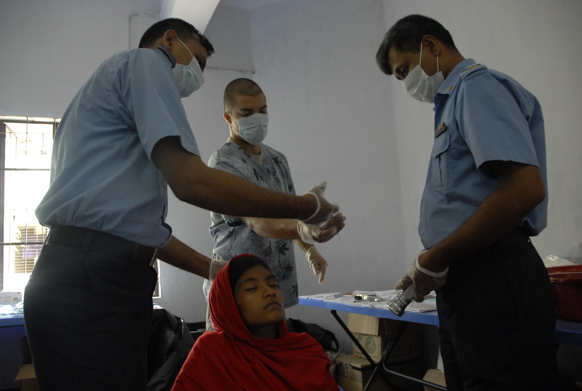 Bangladesh Air Force Squadron Leader Hannan, a dentist, receives an instrument from Staff. Sgt. Michael Maldonado, a dental assistant from the 15th Aeromedical-Dental Squadron at Joint Base Pearl Harbor Hickam, Hawaii, during Operation Pacific Angel in Jessore, Bangladesh, on June 13, 2010.  Operation Pacific Angel is a joint and combined humanitarian assistance operation conducted in the Pacific area of responsibility to support U.S. Pacific Command's capacity-building efforts. This humanitarian and civic assistance program is aimed at improving military civic cooperation between the United States and countries throughout the Asia-Pacific region. More than 55 U.S. military personnel are participating in civil and medical assistance programs with the help of the Bangladesh Air Force and local nongovernmental organizations. Medical care for Bangladesh citizens will include: primary care, women's health, dental and optometry. Several classrooms are being refurbished as part of the mission at the Lauri High School and Primary School. The operation is scheduled through June 16, 2010. (U.S. Air Force photo/1st Lt. Chris Hoyler)