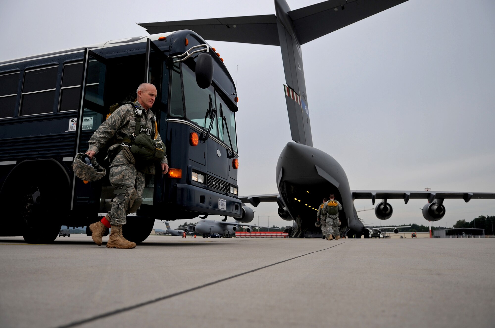 U.S. Air Force Col. Timothy Brown, 435th Contingency Response Group commander, steps off a bus to load a C-17 Globemaster III for an airborne jump, Ramstein Air Base, Germany, June 15, 2010. This airborne jump is officially known as NATO Jump Week and is the first time a NATO jump is conducted from a C-17. Five NATO countries participated in the annual event to support one of United States Air Forces in Europe's top priorities; building partnerships. (U.S. Air Force photo by Airman 1st Class Grovert Fuentes-Contreras)(Released)
