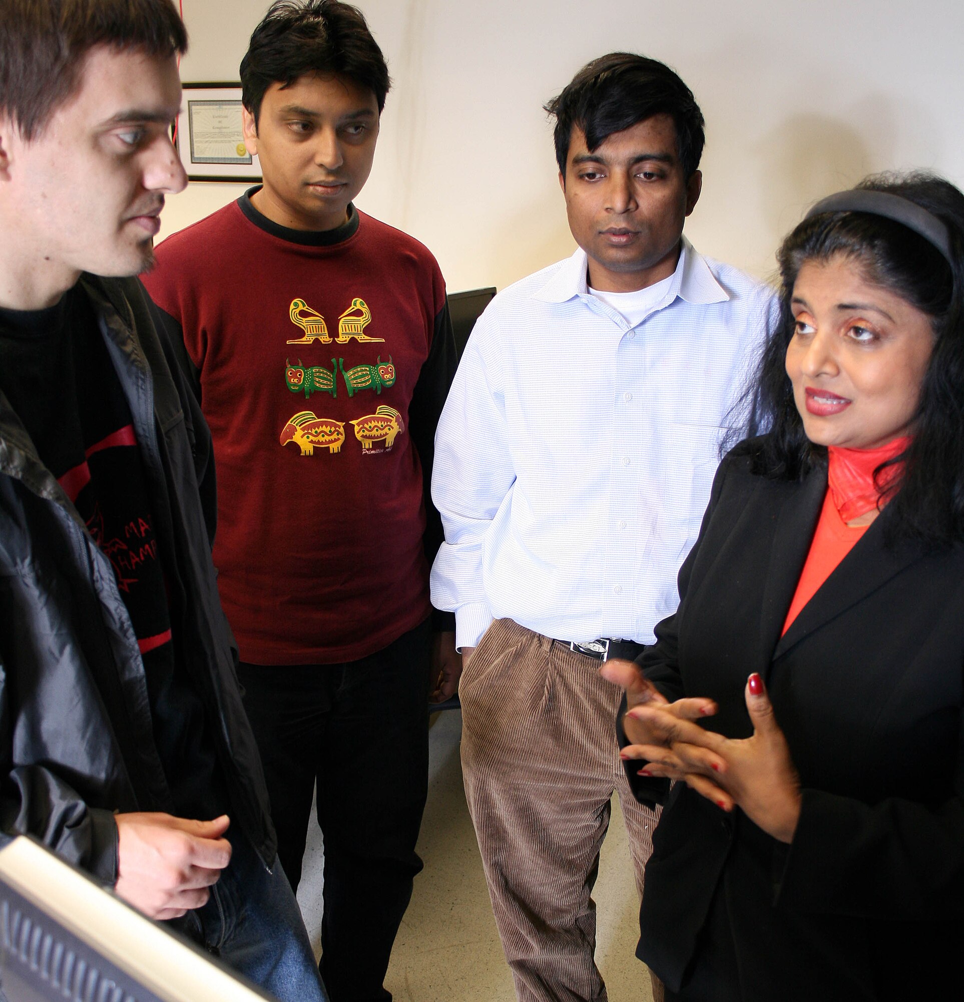 Prof. Thuraisingham is explaining assured information sharing
concepts to Ph.D. student Mr. Jeffrey Partyka in UTD's Cloud Computing
Laboratory. Prof. Latifur Khan and Ph.D Student M. Farhan are listening to
the discussions. (Credit: UTD)
