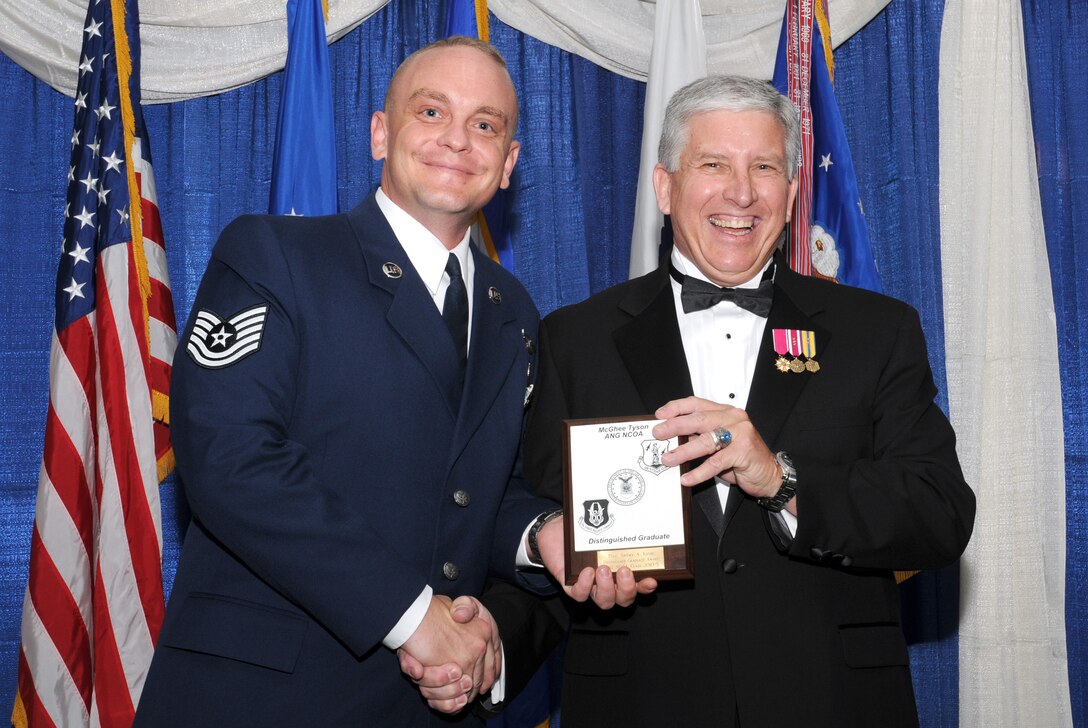 McGHEE TYSON AIR NATIONAL GUARD BASE, Tenn. -- Tech. Sgt. Jeremy A. Kifer, left, from Scott AFB, Ill., receives the distinguished graduate award for NCO Academy Class 10-5 at The I.G. Brown Air National Guard Training and Education Center here from retired Chief Master Sergeant Richard A. Moon, fifth ANG Senior Enlisted Advisor, June 2, 2010. The distinguished graduate award is presented to students in the top ten percent of the class.  It is based on objective and performance evaluations, demonstrated leadership, and performance as a team player. (U.S. Air Force photo by Master Sgt. Kurt Skoglund/Released)