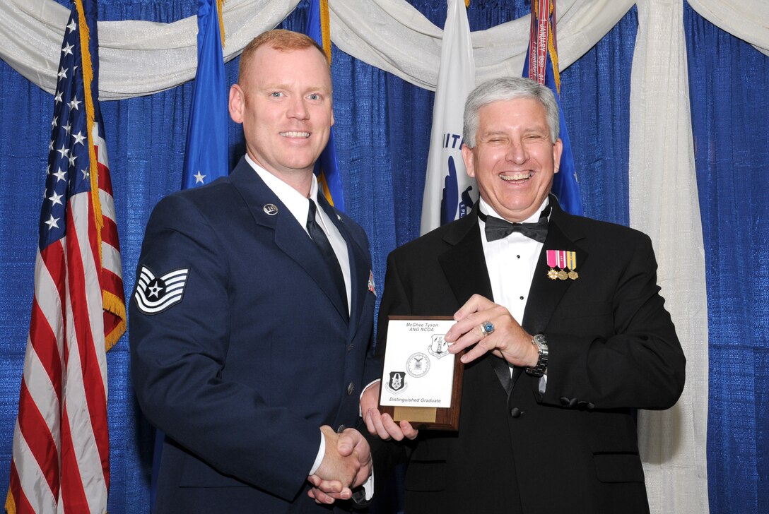 McGHEE TYSON AIR NATIONAL GUARD BASE, Tenn. -- Tech. Sgt. Shawn M. Blair, left, a member of the South Carolina Air National Guard, receives the distinguished graduate award for NCO Academy Class 10-5 at The I.G. Brown Air National Guard Training and Education Center here from retired Chief Master Sergeant Richard A. Moon, fifth ANG Senior Enlisted Advisor, June 2, 2010. The distinguished graduate award is presented to students in the top ten percent of the class.  It is based on objective and performance evaluations, demonstrated leadership, and performance as a team player. (U.S. Air Force photo by Master Sgt. Kurt Skoglund/Released)