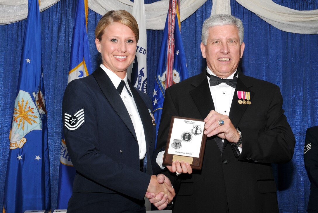 McGHEE TYSON AIR NATIONAL GUARD BASE, Tenn. -- Tech. Sgt. Courtney L. Medack, left, from Whiteman AFB, Mo., receives the distinguished graduate award for NCO Academy Class 10-5 at The I.G. Brown Air National Guard Training and Education Center here from retired Chief Master Sergeant Richard A. Moon, fifth ANG Senior Enlisted Advisor, June 2, 2010. The distinguished graduate award is presented to students in the top ten percent of the class.  It is based on objective and performance evaluations, demonstrated leadership, and performance as a team player. (U.S. Air Force photo by Master Sgt. Kurt Skoglund/Released)