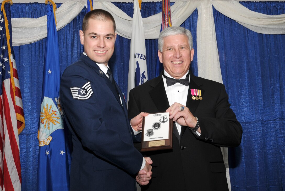 McGHEE TYSON AIR NATIONAL GUARD BASE, Tenn. -- Tech. Sgt. Joseph D. Kull, left, receives the distinguished graduate award for NCO Academy Class 10-5 at The I.G. Brown Air National Guard Training and Education Center here from retired Chief Master Sergeant Richard A. Moon, fifth ANG Senior Enlisted Advisor, June 2, 2010. The distinguished graduate award is presented to students in the top ten percent of the class.  It is based on objective and performance evaluations, demonstrated leadership, and performance as a team player. (U.S. Air Force photo by Master Sgt. Kurt Skoglund/Released)
