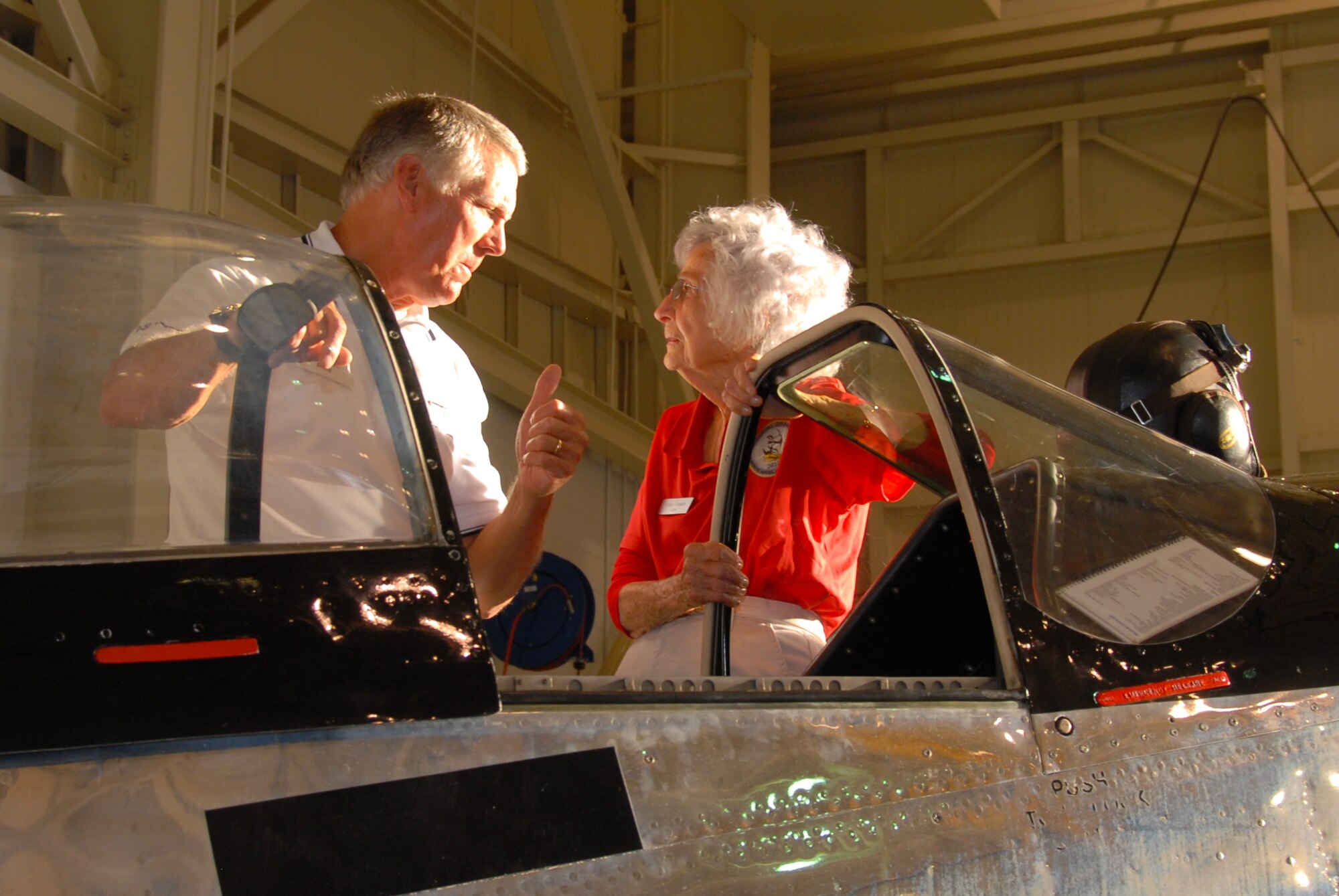 Eagle Violet Cowden talks with the owner of the World War II vintage P-51, “Ain’t Misbehavin’” during the GOE barbecue. Of the 19 aircraft types Ms. Cowden flew during WW II as a WASP, she said the P-51 Mustang was her favorite.(U.S. Air Force photo/Jamie Pitcher)