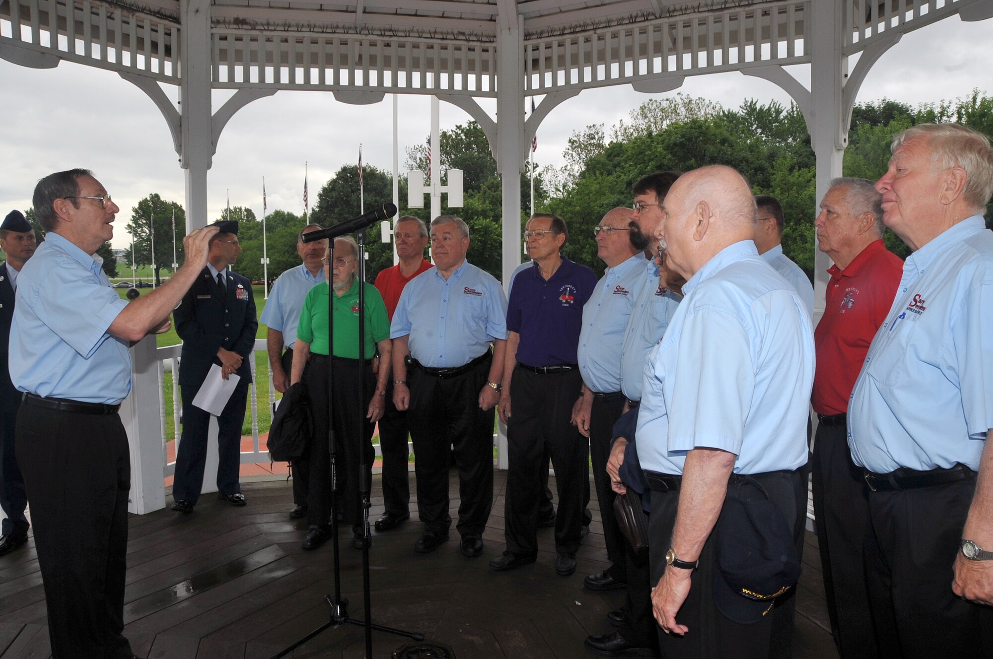 OFFUTT AIR FORCE BASE, Neb. -- The Sarpy Serenaders, a local acapella group, perform patriotic songs in honor of Flag Day during a ceremony at the Offutt Parade Grounds June 14. Members from across Team Offutt gathered to raise multiple American flags lining the Parade Grounds during the ceremony that also included poetry readings. U.S. Air Force Photo by Jeff W. Gates