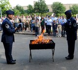 U.S. Air Force Master Sgt. Mark DeCorte, 86th Aeromedical Evacuation Squadron first sergeant and Master Sgt. Mark Lyle, 445th Airlift Wing honor guard superintendent, Wright-Patterson Air Force Base, Ohio, prepare to retire flags during a flag retirement ceremony, Ramstein Air Base, Germany, June 14, 2010.  Flag Day is celebrated with a flag retirement ceremony to remember and retire U.S. Flags that are unserviceable. (U.S. Air Force photo by Airman 1st Class Caleb Pierce)