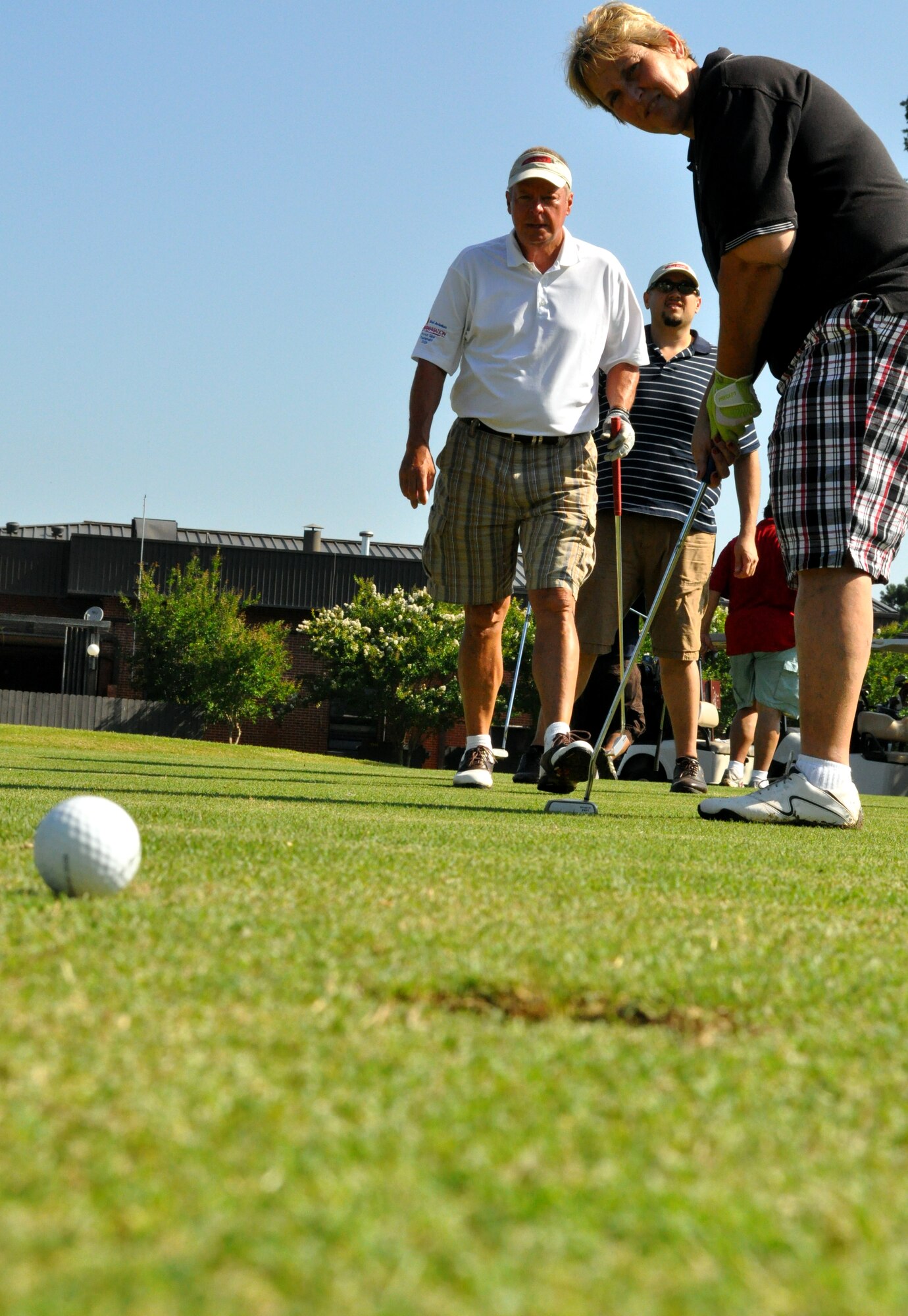 Pam Wickham, 14th Force Support Squadron Marketing, watches as her ball rolls towards the hole during the Super Scramble Golf Tournament at Columbus Air Force Base June 12. Eighteen teams of four competed in the annual event this year. The winning team was Randy Bailey, Jason Kalfus, Darrell Petters and Matt Matthes. (U.S. Air Force photo/Senior Airman Jacob Corbin). 
