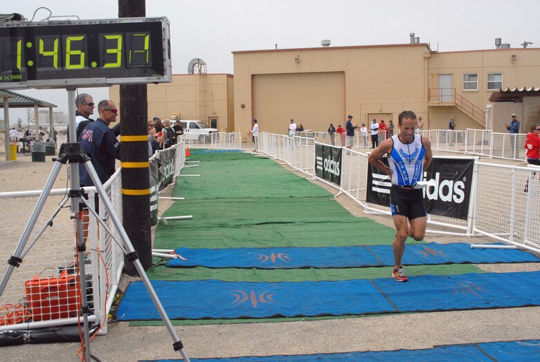 Capt. James Bales is the first to cross the finish line in the men's Armed Forces Triathlon Championship June 5, 2010, at Naval Base Ventura County, Calif. (U.S. Navy photo/Mass Communications Specialist 1st Class Aaron Peterson)