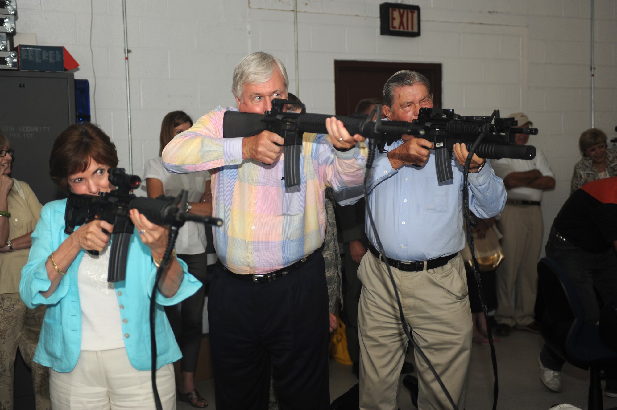 SEYMOUR JOHNSON AIR FORCE BASE, N.C. – Members of the Air Force Civic Leader Alumni Group tour prepare to fire at the 4th Security Forces Squadron firearms training simulator here June 11, 2010. The FATS allows security forces Airmen to practice firing different firearms in situations they may encounter while deployed. The group also visited the 335th Fighter Squadron, fire station, weapons load training facility, end of runway, and aircrew flight equipment facility and tried out the F-15E Strike Eagle flight simulator. (U.S. Air Force photo/Staff Sgt. Heather Stanton)
