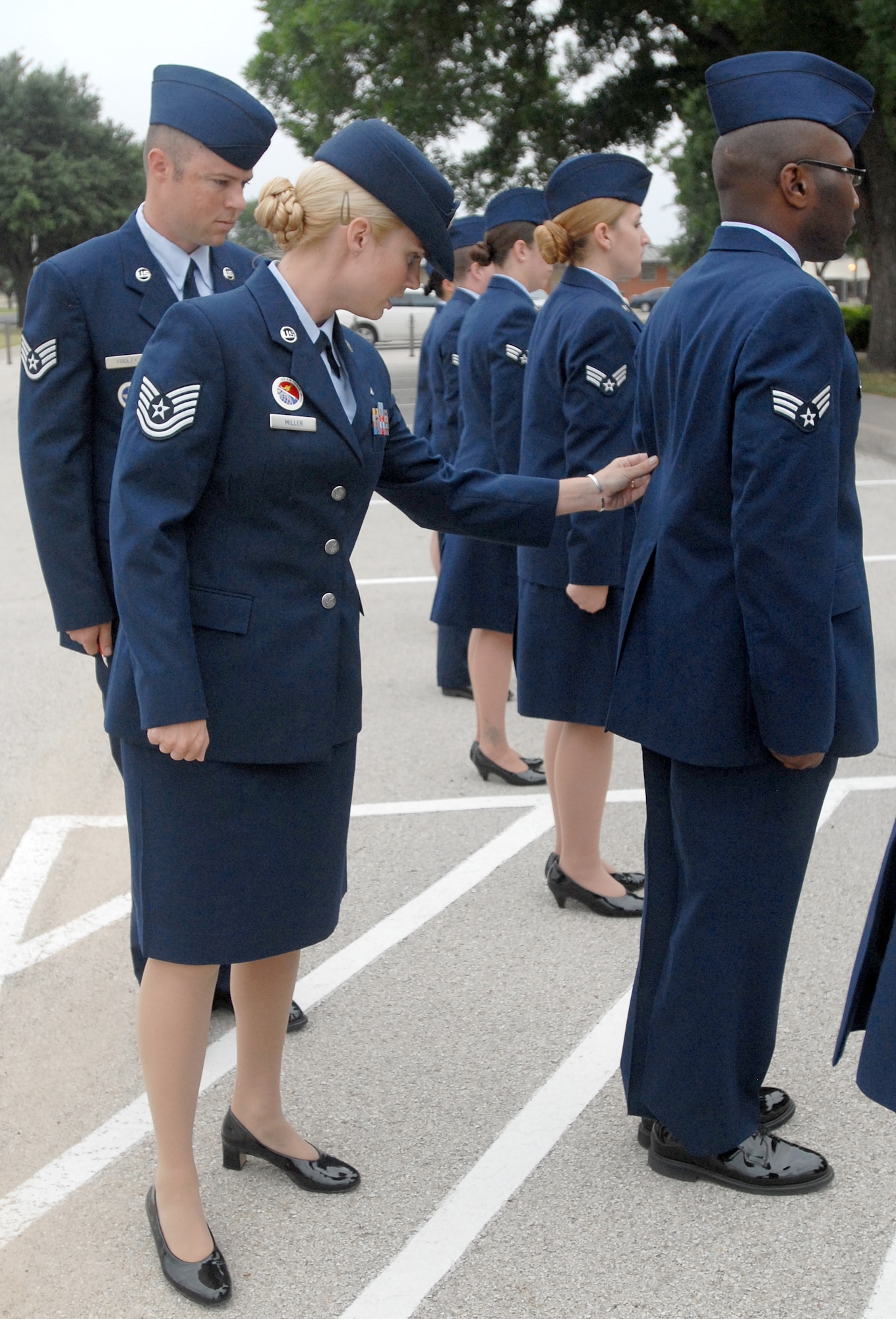 Goodfellow Airman Leadership instructor, Tech Sgt. April Miller, and class leader, Staff Sgt. Anthony Fridley, conduct an open ranks inspection of Class 10-G1 in Service Dress June 14.  Uniform inspections are a key part of all enlisted professional military education and help to instill pride in the individual’s uniform. (U.S. Air Force photo/Master Sgt Randy Mallard)