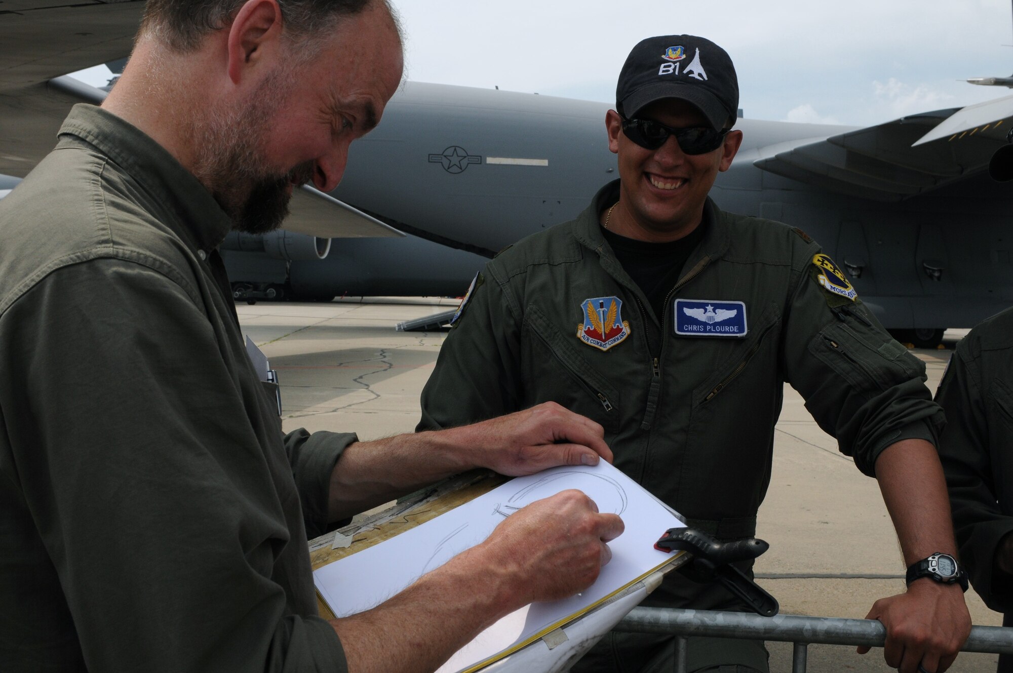 Falk-Ingo Renner, from Dresden, Germany, draws a caricature of Maj. Chris Plourde, 28th Bomb Squadron assistant director of operations, during the ILA 2010 Berlin International Aerospace Exhibition and Conferences June 11. The Berlin Air Show is one of the premier events of its kind in the world. (U.S. Air Force photo/Staff Sgt. Julius Delos Reyes)
