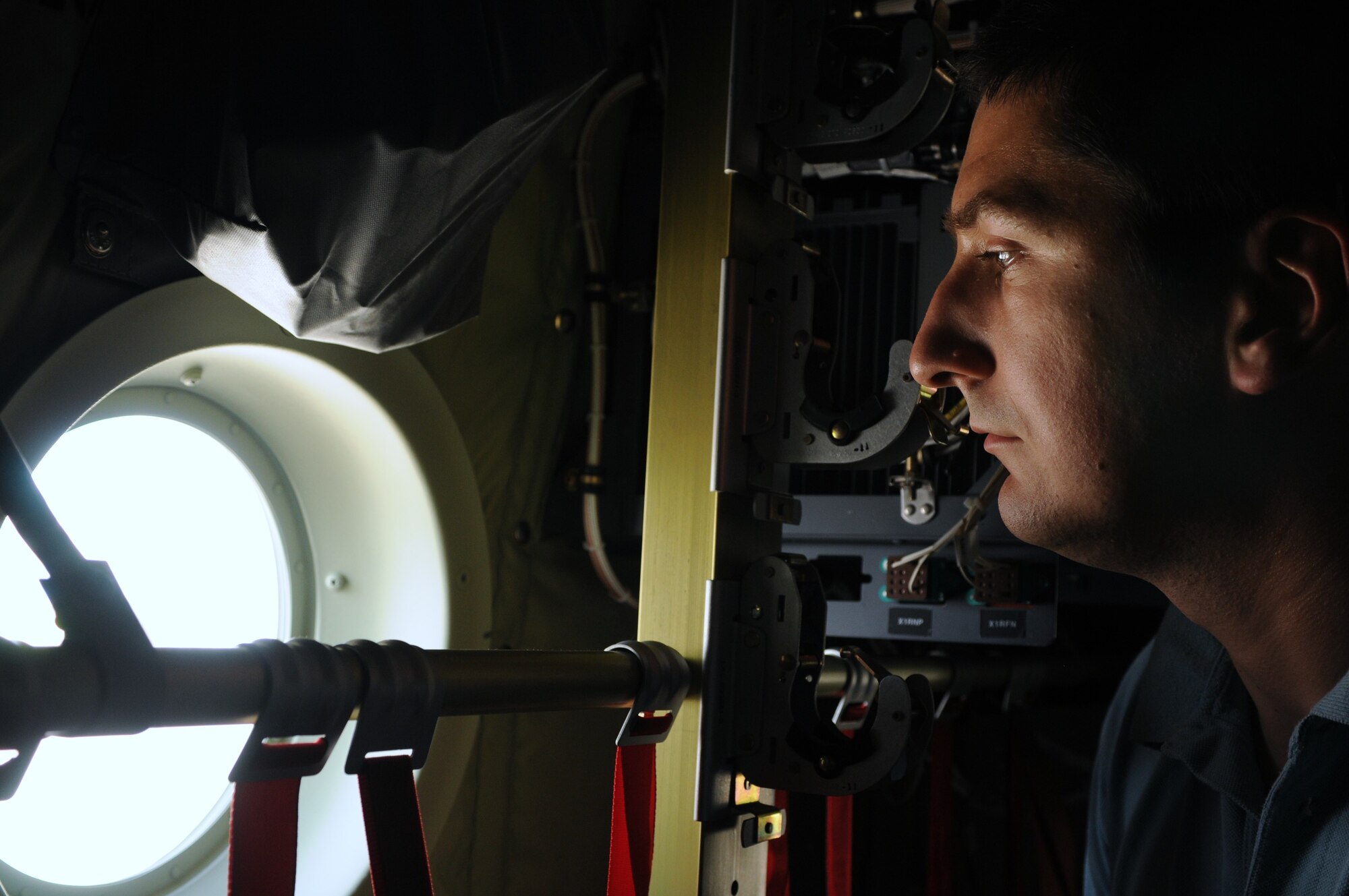 Mihai Enescu, from Ploiest, Romania, looks out of the window of a C-130J Hercules during the 2010 Berlin International Aerospace Exhibition and Conferences June 10. The Berlin Air Show is one of the premier event of its kind in the world. (U.S. Air Force photo/Staff Sgt. Julius Delos Reyes)