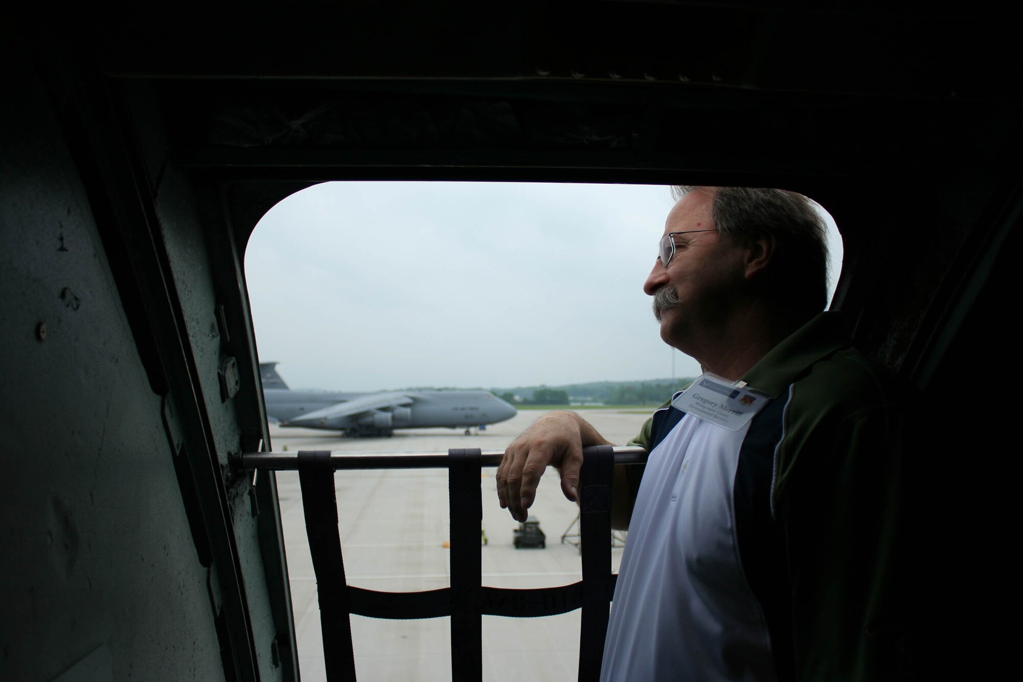 WRIGHT-PATTERSON AIR FORCE BASE, Ohio – Mr. Gregory Merrill, Montgomery County Environmental Services, enjoys the view from the flightline while looking out of a C-5 Galaxy aircraft during the 445th Airlift Wing Employer Appreciation Day June 5.  Mr. Merrill and forty two other employers had the opportunity to spend the day at the wing to see exactly where their Air Force Reserve employees work and what they do on unit training assembly weekends. (U.S. Air Force photo/Tech. Sgt. Jeremy Caskey)


