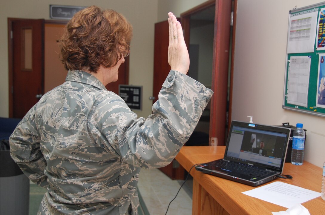 U.S. Air Force Lt. Col. Maureen Carroll, 386th Expeditionary Maintenance Squadron commander, swears her son, now-2nd Lt. Alek Krallman, into the U.S. Air Force here June 13, 2010 over the Internet during his Air Force Reserve Officer Training Corps graduation from Central Washington University in Ellensburg, Wash. Colonel Carroll is deployed from Joint Base Lewis-McChord, Wash. (U.S. Air Force photo by Tech. Sgt. Lindsey Maurice/Released)   