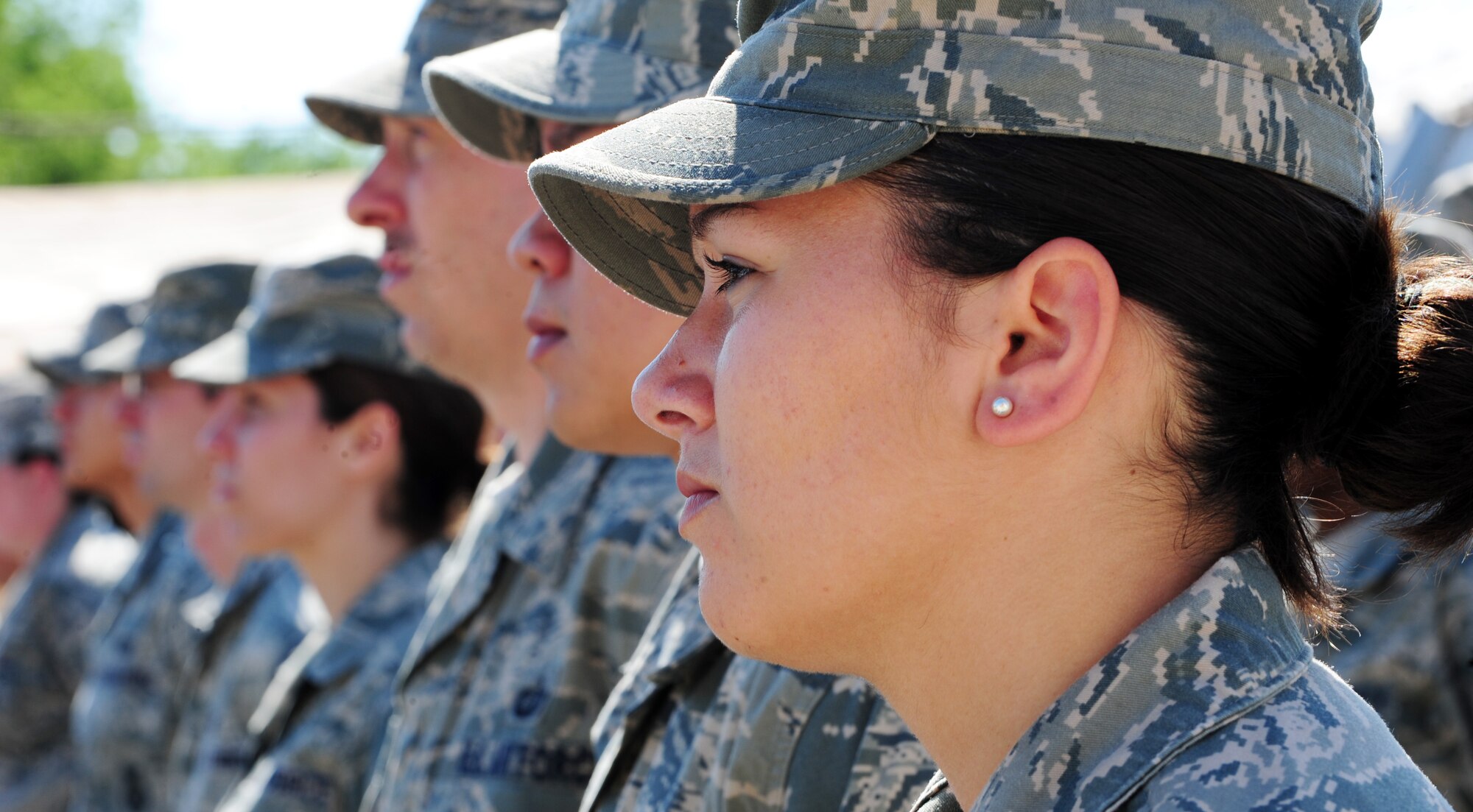 Senior Airman Jessica Johnson, 376th Expeditionary Medical Group laboratory technician, stands in formation to witness the formal change of command ceremony at the Transit Center at Manas, Kyrgyzstan, June 15, 2010. Col. Blaine D. Holt relinquished command of the 376th Air Expeditionary Wing to Col. Dwight C. Sones. Presiding over the change of command was Lt. Gen. Mike Hostage, Commander, U.S. Air Forces Central Command, Southwest Asia. (U.S. Air Force photo/ Senior Airman Nichelle Anderson/ released)