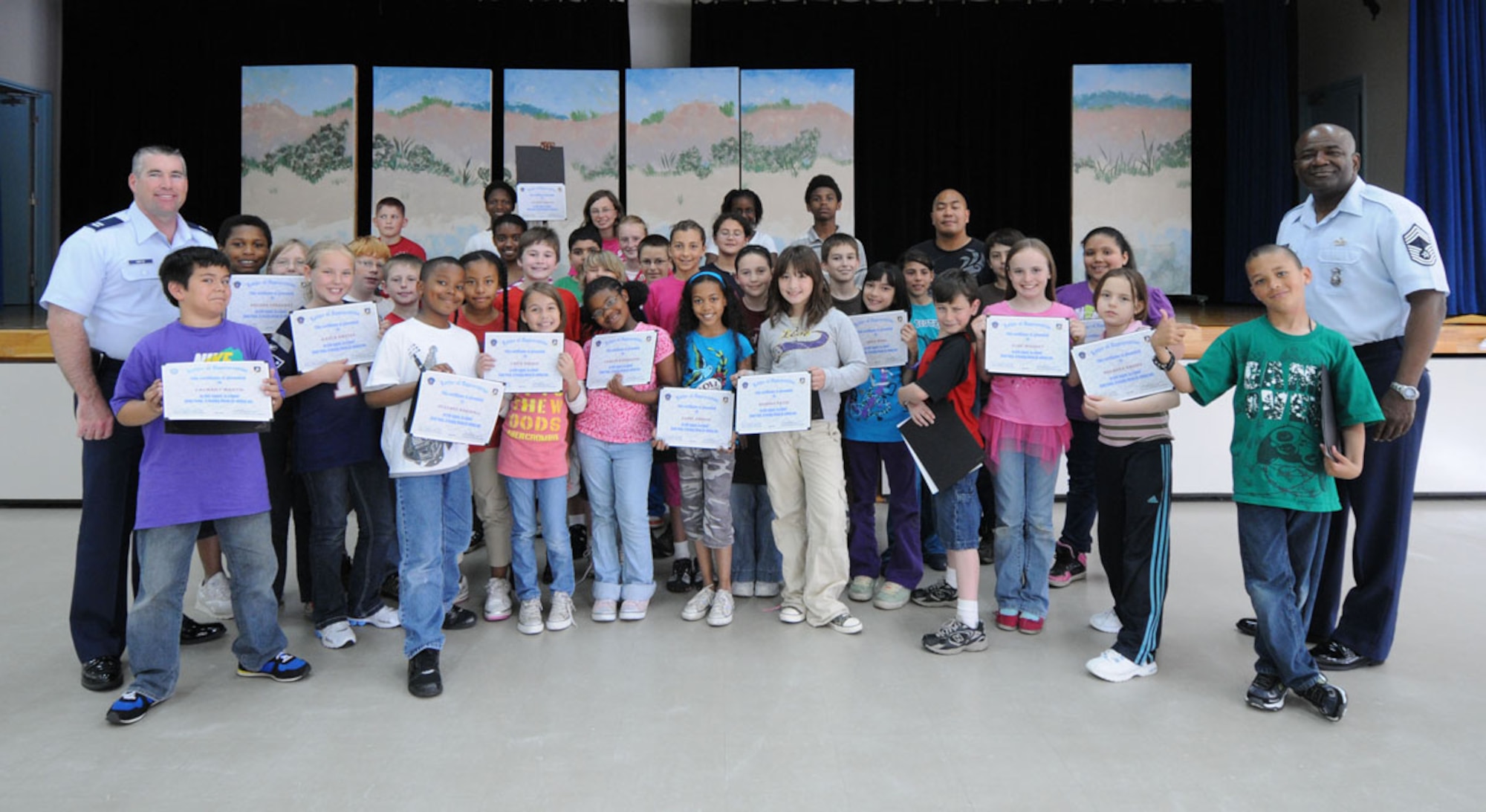MISAWA AIR BASE, Japan – Captain Leo Martin, 35th Security Force Squadron commander, and Chief Master Sgt. John Gammage, 35th SFS manager, present certificates of appreciation, June 14, to Sollars Elementary School students who volunteered in the safety patrol program. The 35th SFS leadership applauded safety patrolmen from Sollars and Cummings Elementary Schools for their efforts in keeping the base’s children and parents safe while walking to school. (U.S. Air Force photo/Senior Airman Jessica Lockoski)   