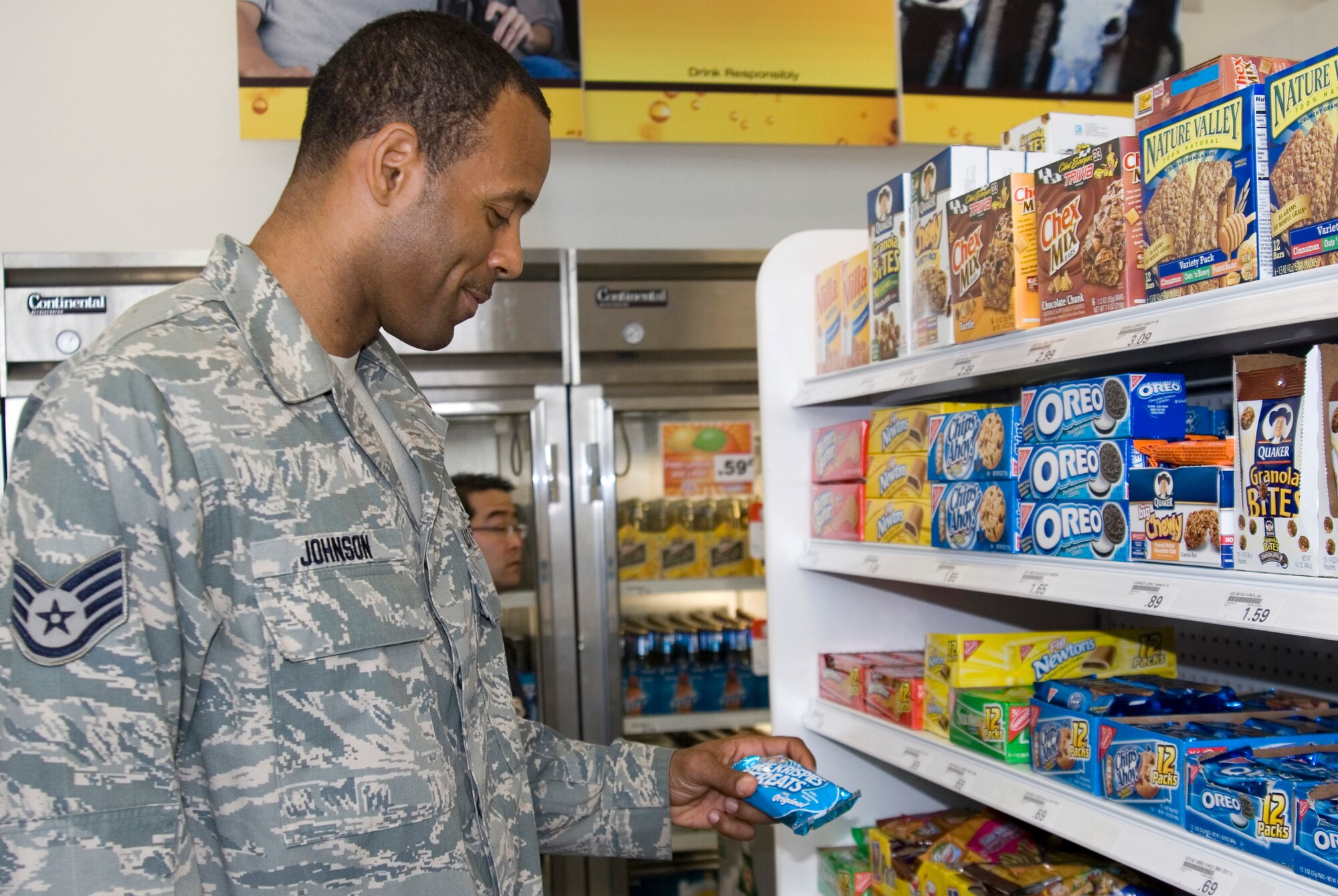 KUNSAN AIR BASE, Republic of Korea -- Staff Sgt. Adrian Johnson, 8th Comptroller Squadron financial technician, contemplates buying a snack during the grand opening of the new base shoppette. The shoppette construction began April 26 and was complete on May 26, costing approximately $41,000 to build. The hours of operation are 7:30 a.m. to 10 p.m. Monday through Thursday, 7:30 a.m. to 11 p.m. Friday and Saturday, and 10 a.m. to 10 p.m. Sunday. (U.S. Air Force photo/Staff Sgt. Jonathan Pomeroy)