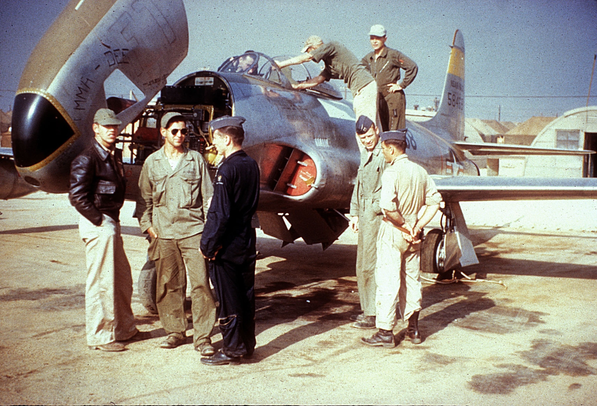 Ground crew prepare to fit the RF-80 "Emma-Dee" with nose cameras as reconnaissance pilots  watch. (U.S. Air Force photo)