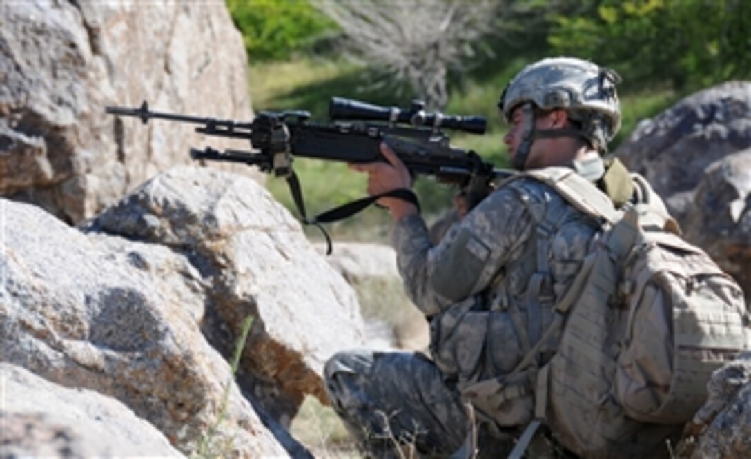 U.S. Army Spc. Michael Rockwell, a combat infantryman with 1st Platoon, Delta Company, 1st Battalion, 4th Infantry Regiment, U.S. Army Europe, scans the surrounding mountains for threats during a patrol outside Forward Operating Base Baylough in Zabul province, Afghanistan, on June 12, 2010.  