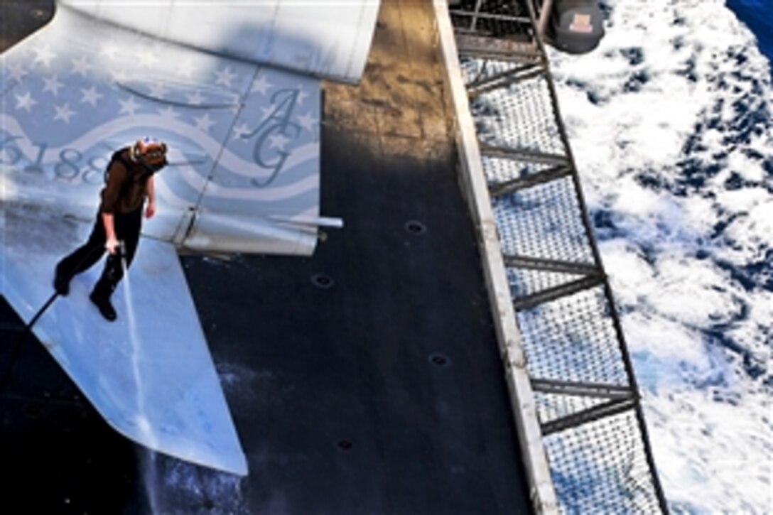 A U.S. Navy sailor cleans an EA-6B Prowler on the flight deck of the USS Dwight D. Eisenhower in the Arabian Gulf, June 12, 2010. 