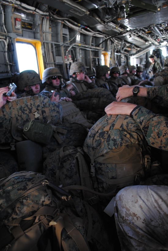Marines in Weapons Company, 1st Battalion, 24th Marine Regiment, load on a CH-53E, and prepare to drop into a landing zone for Exercise Javelin Thrust 2010.