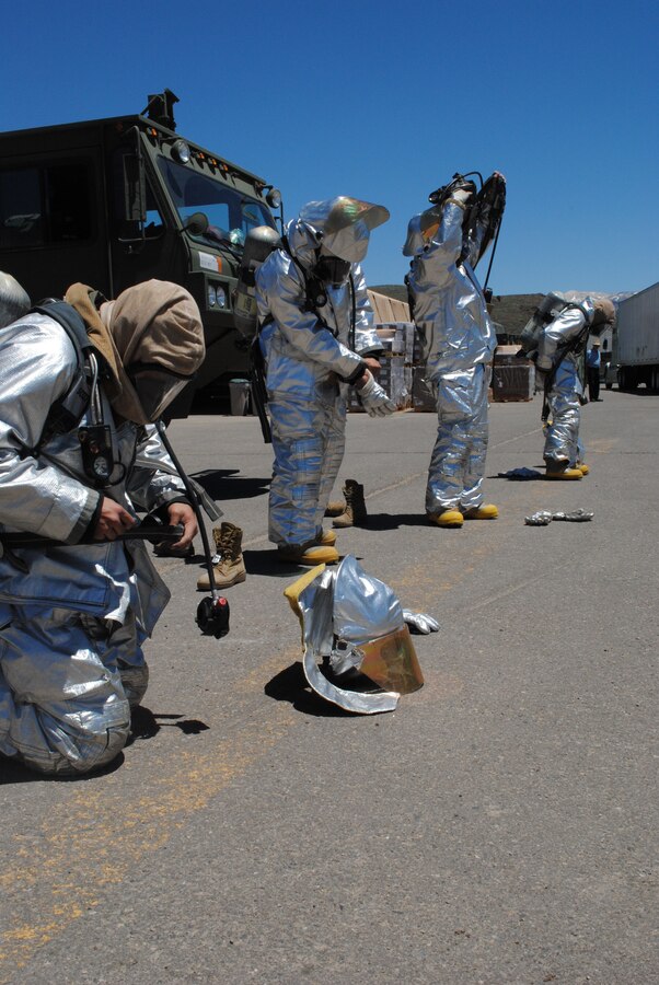 Marines with Marine Wing Support Squadron 473, Crash Fire and Rescue, train to remove bunker suits during Exercise Javelin Thrust 2010.
