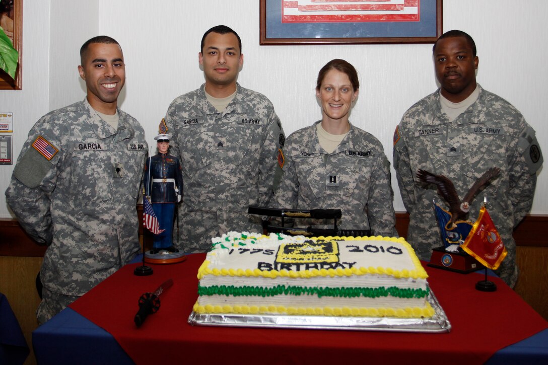 From left to right Spc. Sherwin Garcia, Sgt. Chris Garcia, Capt. Kimberly Yore and Sgt. Rabosky Tanner celebrate the Army’s birthday at the south side mess hall here June 15.