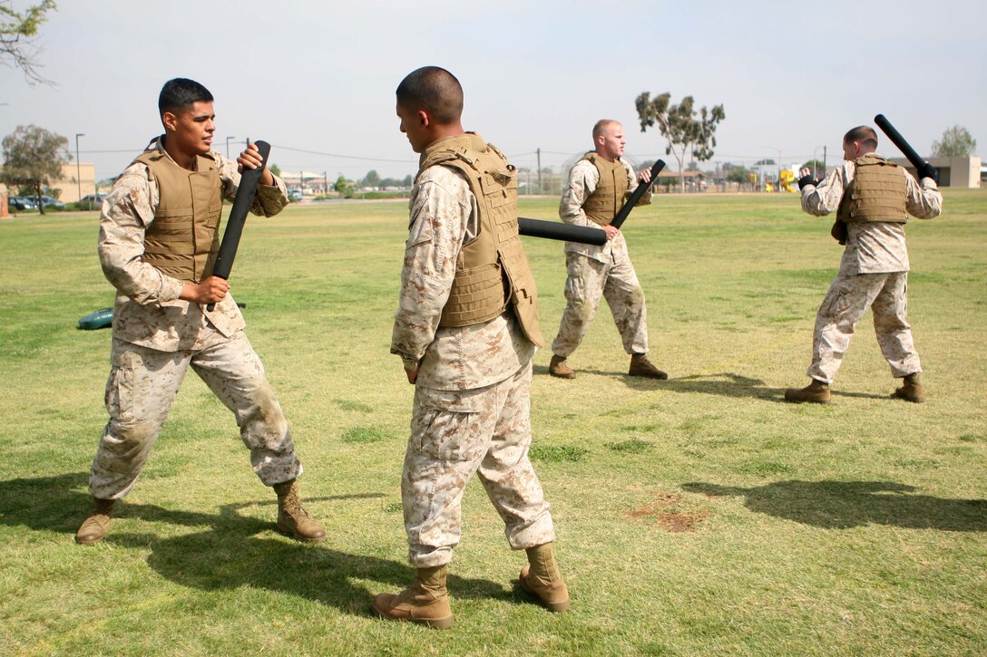 Marine Corps Martial Arts Program students with Marine Corps Air Station Miramar's Headquarters and Headquarters Squadron practice blocking and striking during a MCMAP class here June 15. The class incorporated combat conditioning, MCMAP techniques and mentoring sessions.
