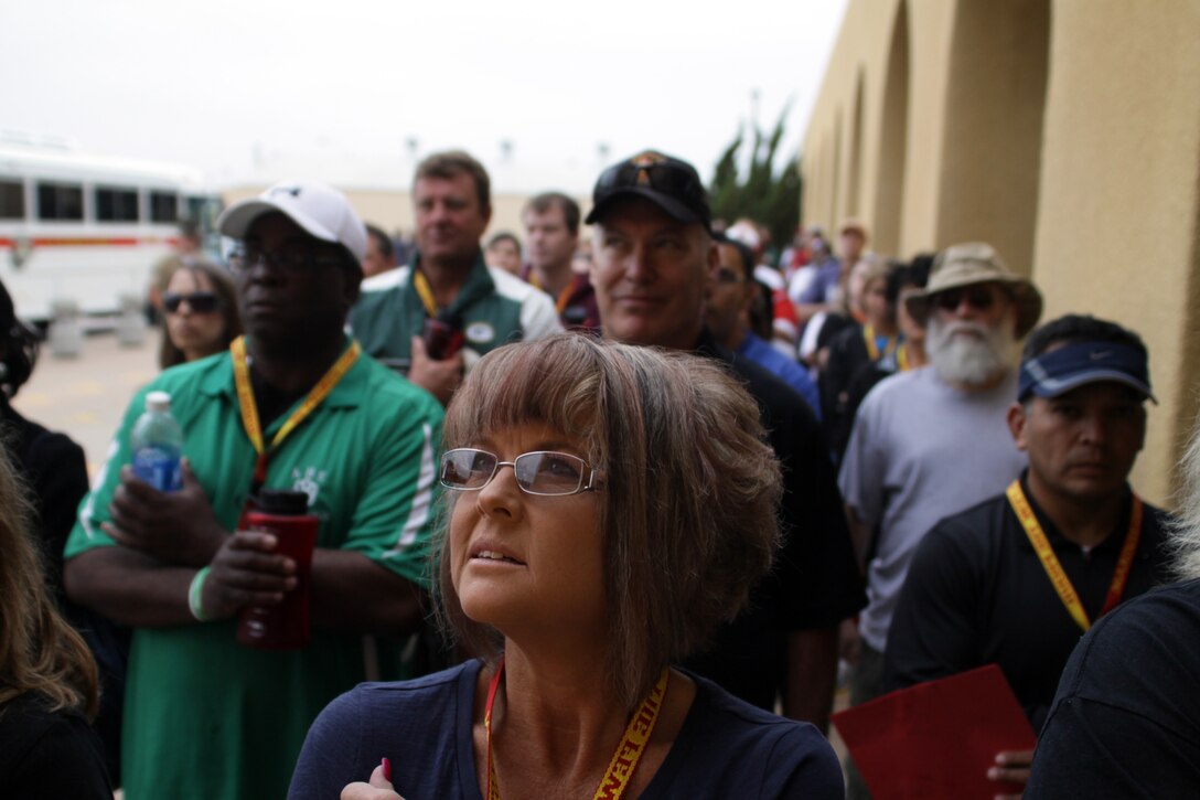 Nancy Phipps, language arts teacher, Carlsbad High School, Carlsbad, N.M. reads the Articles of the Uniform Code of Military Justice while she and her fellow visiting educators stand on the yellow footprints June 15. The educators got a taste of recruit training during their weeklong visit, starting with a simulation of the receiving process for recruits beginning recruit training.