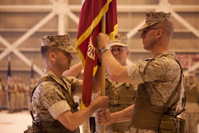 U.S. Marine Lt. Col. Christopher A. Feyedelem passes the organizational colors to U.S. Marine Lt. Col. Michael C. Taylor during the Marine Wing Support Squadron 171 change of command ceremony aboard Marine Corps Air Station Iwakuni, Japan, June 15, 2010. The exchange of the organizational colors is symbolic of the transfer of command from the outgoing commanding officer to the incomming commanding officer.