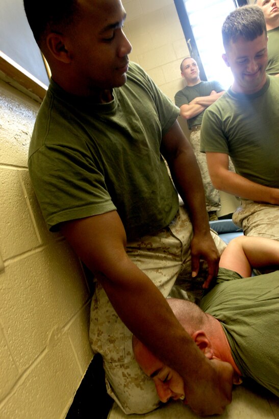 MARINE CORPS BASE CAMP LEJEUNE, N.C. -- A Marine with Brig Company, Headquarters and Support Battalion, Marine Corps Base Camp Lejeune, keeps a hold of role-playing inmate Lance Cpl. Vincent Martone during the demonstration portion of a prisoner cell transfer exercise at the Camp Lejeune brig, June 16. Soldiers with 308th Military Police Company Internment/Resettlement, United States Army Reserve, learned transfer noncompliant inmates as part of the training for their upcoming deployment.