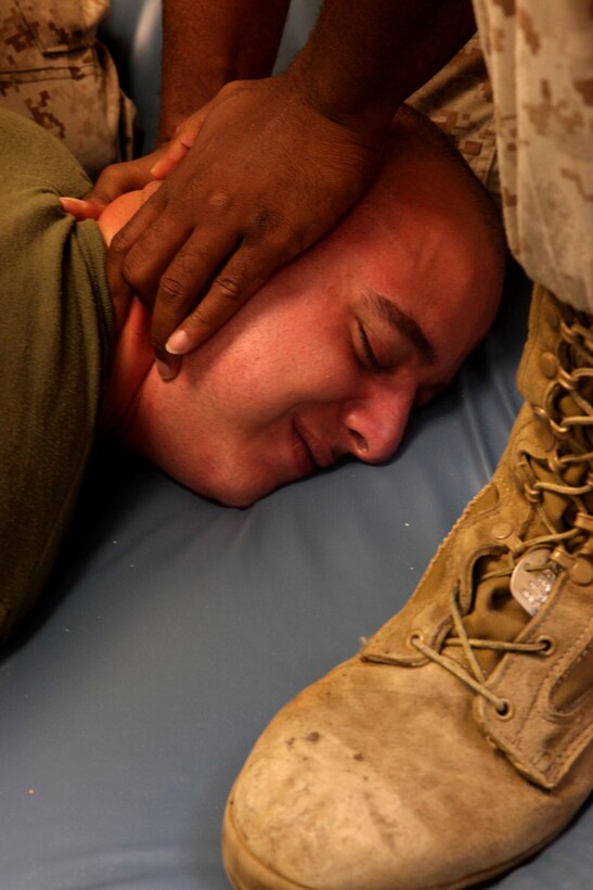 MARINE CORPS BASE CAMP LEJEUNE, N.C. - Lance Cpl. Vincent Martone, a brig guard with Brig Company, Headquarters and Support Battalion, Marine Corps Base Camp Lejeune, is subdued by other Marines during a prisoner cell transfer exercise, June 16. The exercise taught soldiers with 308th Military Police Company Internment/Resettlement, United States Army Reserve, how to transfer a noncompliant prisoner to a different cell as part of their predeployment training.