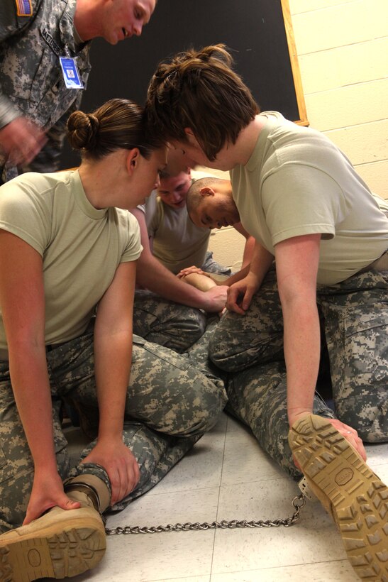 MARINE CORPS BASE CAMP LEJEUNE, N.C. -- Soldiers with 308th Military Police Company Internment/Resettlement, United States Army Reserve, subdued a fellow soldier playing the role of a noncompliant prisoner during a prisoner cell transfer exercise at the Camp Lejeune Brig, June 16. The exercise taught the soldiers how to transfer a noncompliant prisoner to a different cell as part of their predeployment training.