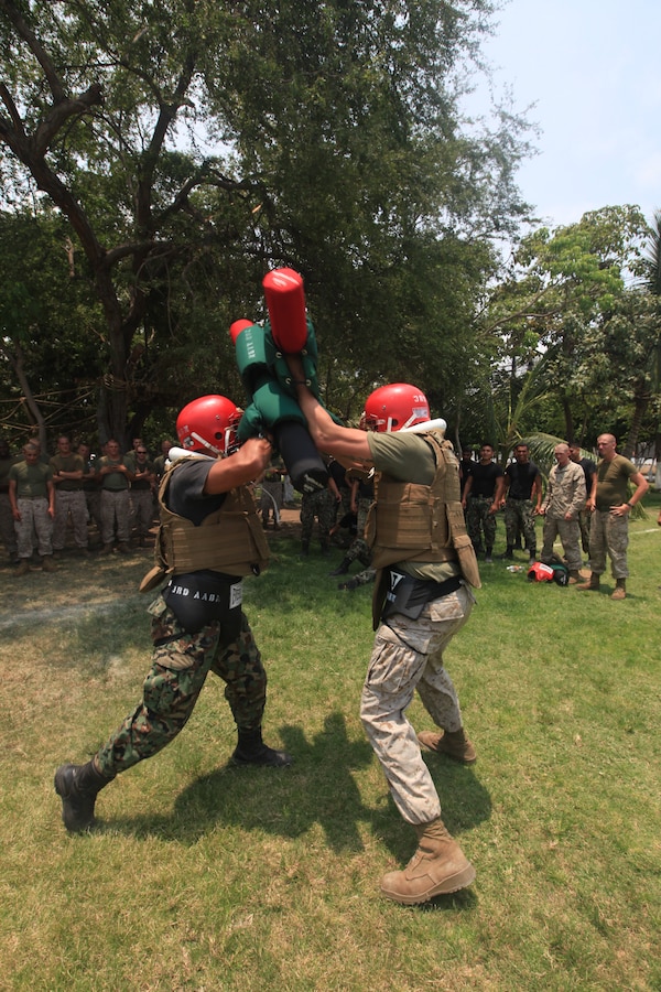 Cpl Christopher A. Franciose , a U.S. Marine with 4th platoon, Company C, 3d Assault Amphibian Battalion, 1st Marine Division, engages a Mexican Marine during a pugil stick exercise in Colima, Mexico, June 16.