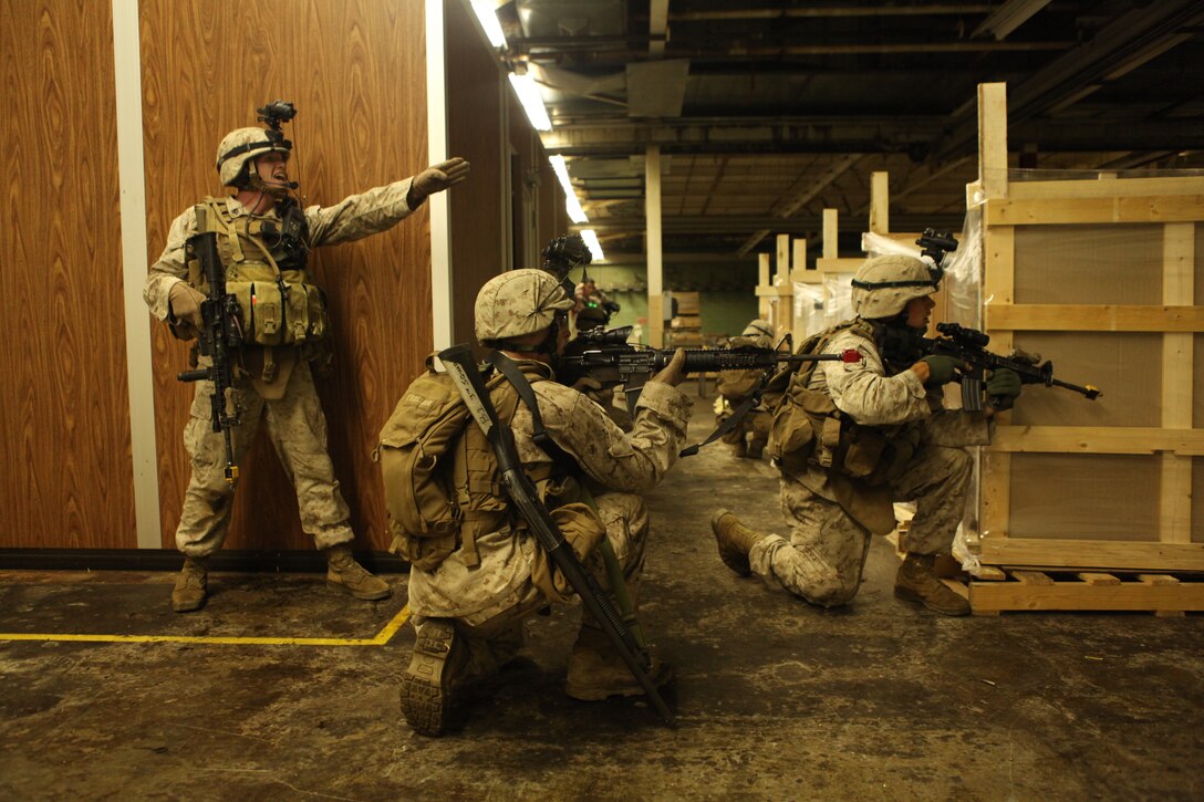 Marines with Company K, Battalion Landing Team 3/8, 26th Marine Expeditionary Unit, clear a building during a simulated night raid at a local lumberyard in Tappahannock, Va., June 16, 2010. During Realistic Urban Training (RUT) at nearby Fort A.P. Hill, Va., the MEU conducted several urban training exercises in a realistic environment as part of its pre-deployment training. The urban environment is among the most challenging tactical environments MEU Marines may face. 26th MEU is scheduled to deploy later this fall.