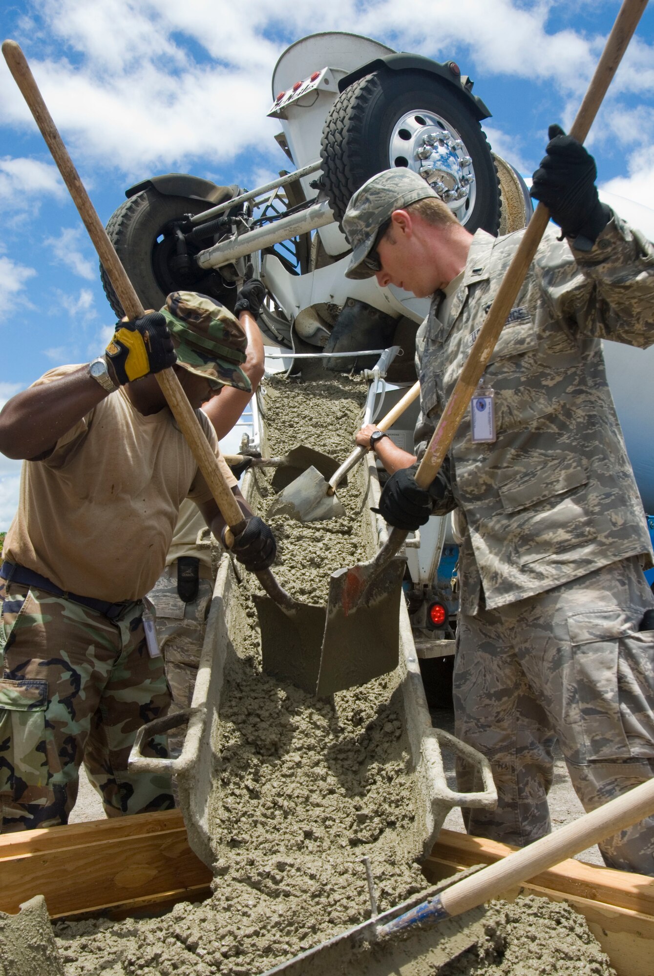 1st Lt. Ryan Barry assists Staff Sgt. Brent Parker from the 146th Civil Engineering Squadron with a concrete pour on Pearl City’s Naval Base in Hawaii, June 14, 2010. The Civil Engineering Squadron is assisting with various construction projects at Pearl City Naval Base and U.S. Coast Guard Air Station, Barbers Point from June 4-18, 2010. (DoD photo by Airman 1st Class Nicholas Carzis, U.S. Air Force)