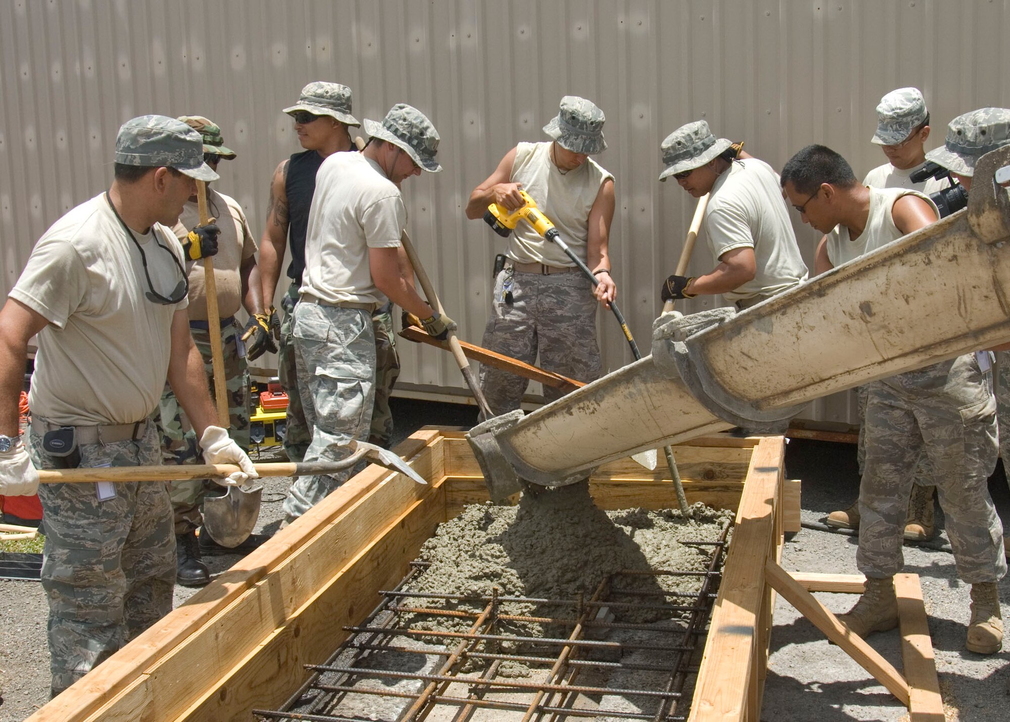 Airmen from the 146th Civil Engineering Squadron known as the “dirt boys” assist with a concrete pour on Pearl City’s Naval Base in Hawaii, June 14, 2010. The Civil Engineering Squadron is assisting with various construction projects at Pearl City Naval Base and U.S. Coast Guard Air Station, Barbers Point from June 4-18, 2010. (DoD photo by Airman 1st Class Nicholas Carzis, U.S. Air Force)