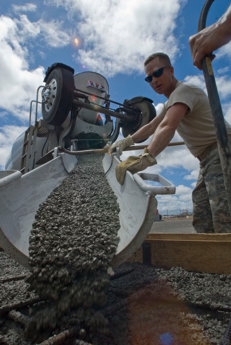 Staff Sgt. Cris Casteel of the 146th Airlift Wing’s Civil Engineering Squadron maneuvers the concrete chute during a concrete pour at Pearl City’s Naval Base in Hawaii, June 14, 2010. The Civil Engineering Squadron is assisting with various construction projects at Pearl City Naval Base and U.S. Coast Guard Air Station, Barbers Point from June 4-18, 2010. (DoD photo by Airman 1st Class Nicholas Carzis, U.S. Air Force)