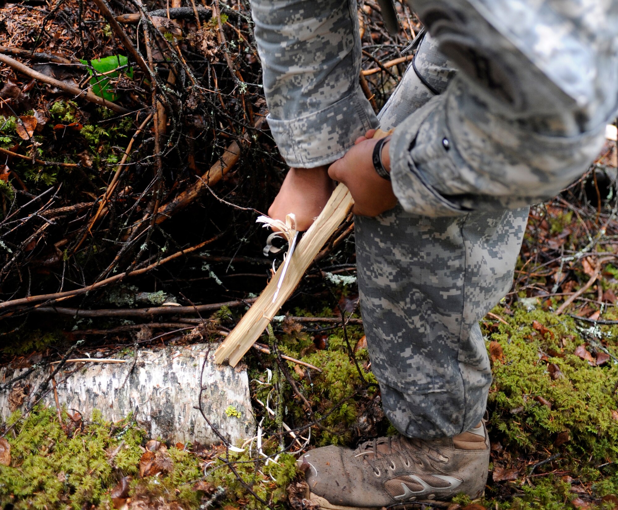 Sergeant Suarez carves a feather stick June 9, 2010, Eielson Air Force Base, Alaska. A feather stick allows fires to catch more easily due do the thinner material that will burn to the bulk of the stick. Sgt. Suarez is assigned to the 358 Civil Engineer Brigade from March Air Force Base. (U.S. Air Force photo/Airman 1st Class Willard E. Grande II)