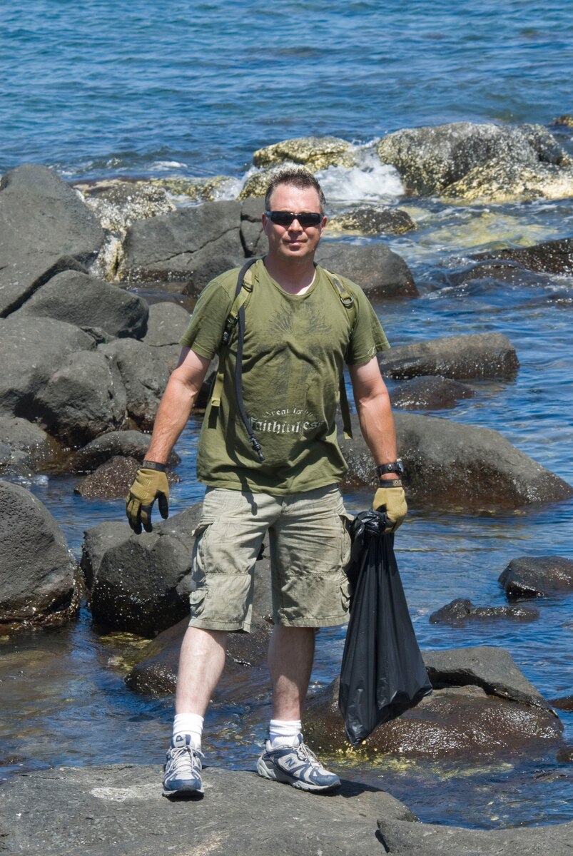 Master Sgt. Don Simmons helps pick up trash at Laniakea Beach on Oahu’s North Shore June 11, 2010. The 146th AW Civil Engineering Squadron participated in the project alongside the organization “Malama nu Honu,” a non-profit group that works to protect the Hawaiian Green Sea Turtle through education, public awareness and conservation. (DoD photo by Airman 1st Class Nicholas Carzis, U.S. Air Force/Released)
