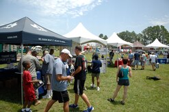 Airmen and family members visit a plethora of sponsored booths located throughout the picnic grounds during the annual base picnic at Joint Base Charleston, S.C. June 11, 2010.This two-day event hosted activities for both adults and children, ranging from a car show and live entertainment for adults, to a free movie and several giant inflatables for children to play on. (U.S. Air Force photo/Senior Airman Timothy Taylor)