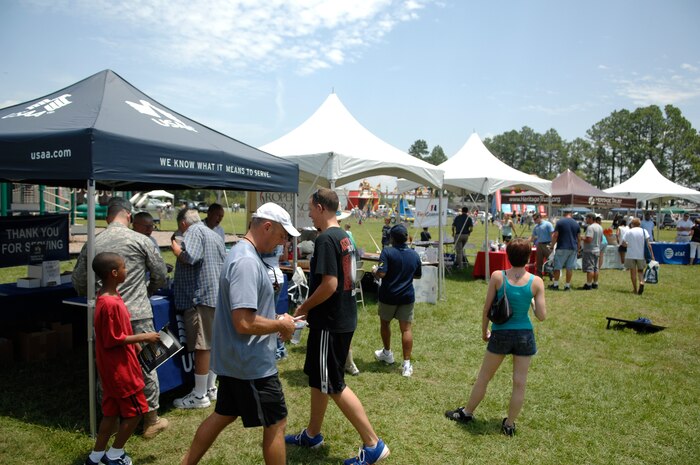 Airmen and family members visit a plethora of sponsored booths located throughout the picnic grounds during the annual base picnic at Joint Base Charleston, S.C. June 11, 2010.This two-day event hosted activities for both adults and children, ranging from a car show and live entertainment for adults, to a free movie and several giant inflatables for children to play on. (U.S. Air Force photo/Senior Airman Timothy Taylor)
