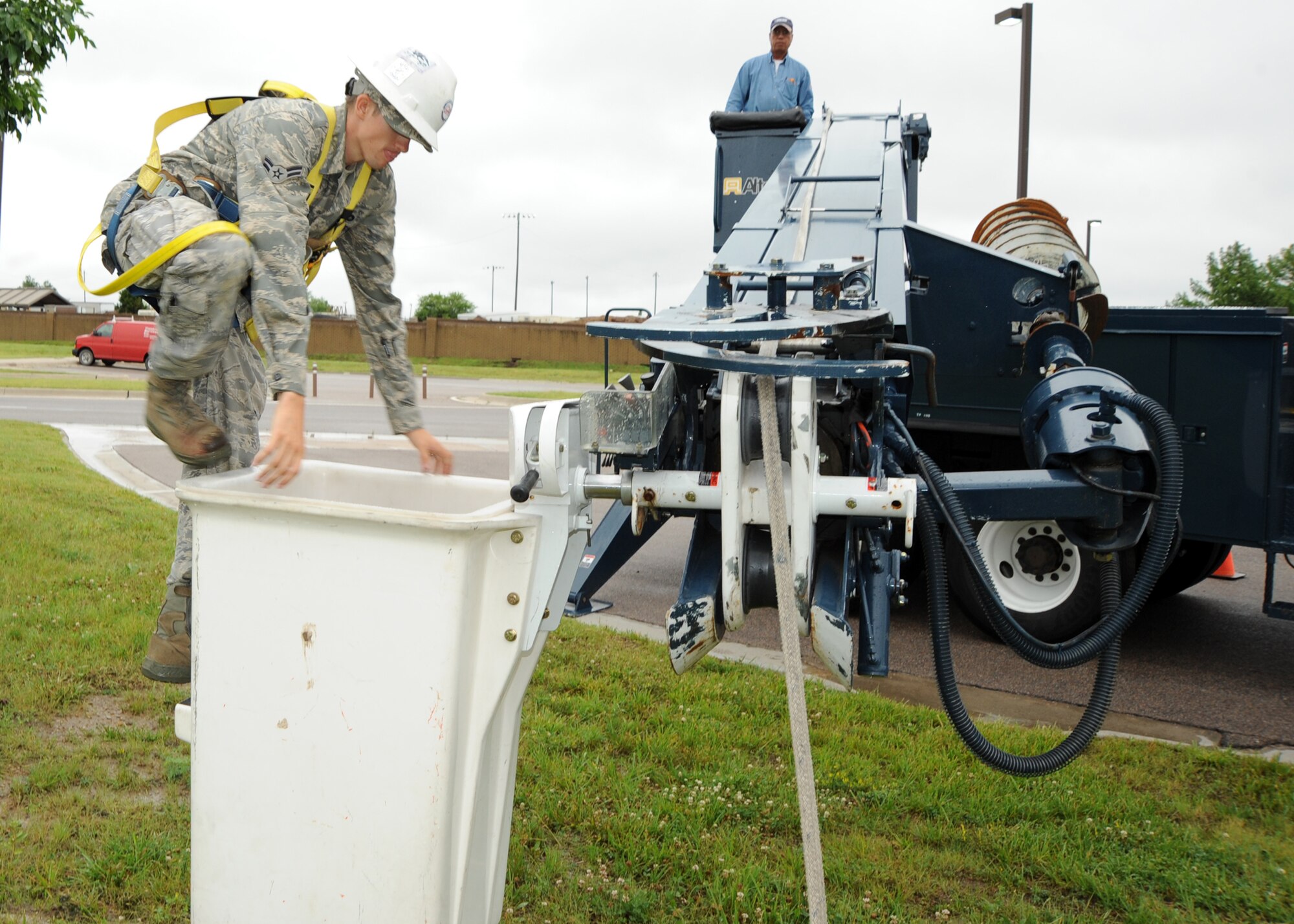 Airman 1st Class John Mitchell, 22nd Civil Engineer Squadron electrical systems apprentice, enters a line truck’s utility bucket, June 9, 2010, McConnell Air Force Base, Kan.  Electrical systems Airmen climb utility poles and operate special purpose vehicles and equipment, including line and high reach trucks, to inspect, maintain and repair overhead electrical systems at McConnell.   Electrical systems Airmen  perform the same duties and responsibilities as a civilian electrician working for commercial power companies.  (U.S. Air Force/photo Airman 1st Class Andrea Salazar)