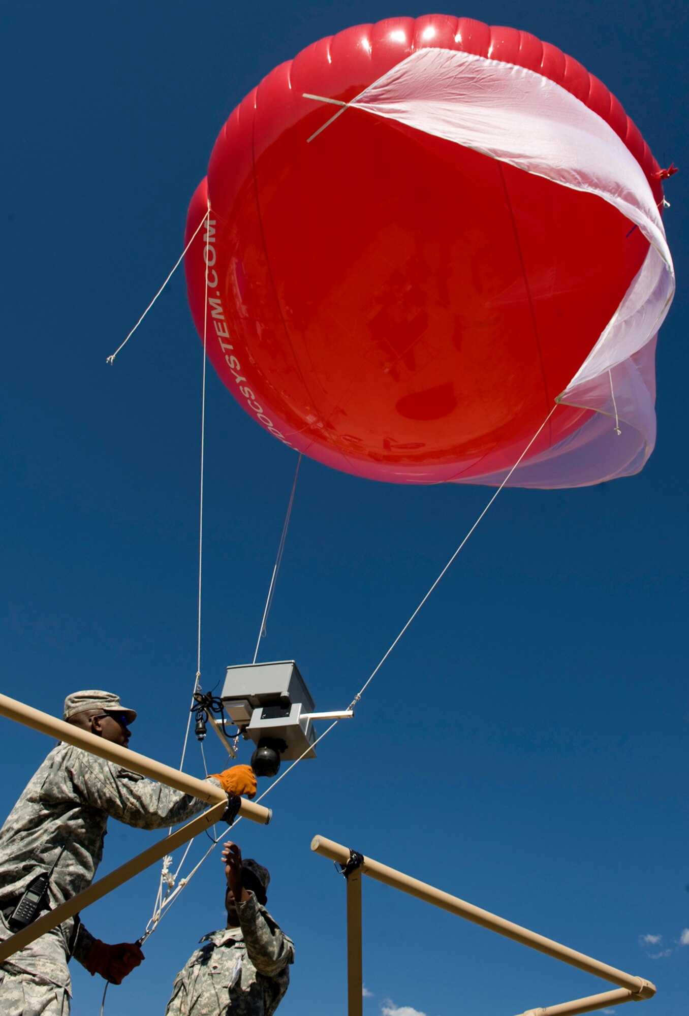 Soldiers participating in the Coalition Warrior Interoperability Demonstration June 16, 2010, in Colorado Springs, Colo., prepare a balloon carrying communications and video equipment. The balloon is being used to test new communications capabilities between Department of Defense organizations and local emergency services in situations where normal communications have been disabled. (U.S. Air Force photo/Master Sgt. Jack Braden)